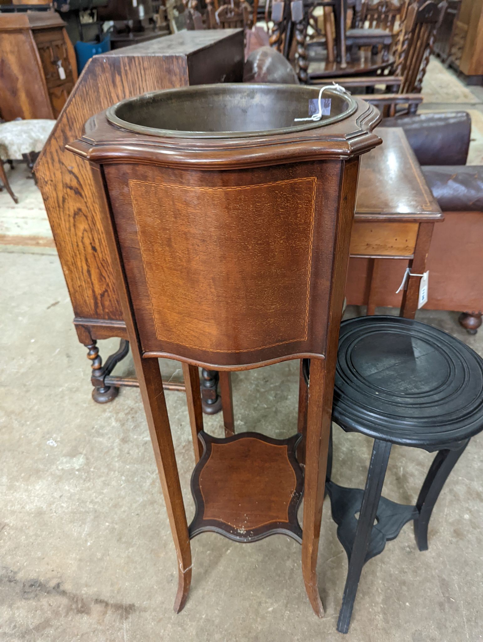 An Edwardian inlaid mahogany jardiniere with brass liner, height 99cm together with a small ebonised plant stand